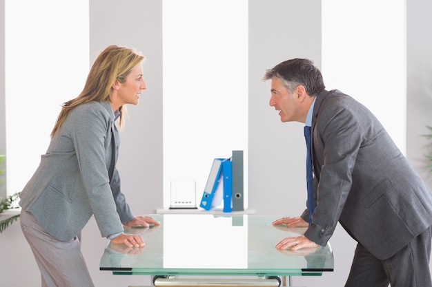 A manager talking to an employee in a one-on-one meeting, explaining new responsibilities and opportunities for growth within the company, illustrating the communication needed for successful quiet hiring.