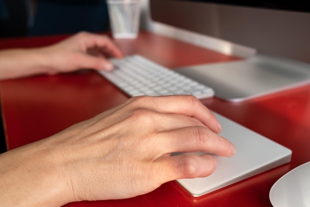 A close-up of an employee's hands typing on a keyboard, with a calendar reminder for 