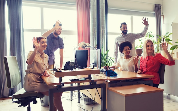 A diverse team celebrating project success in a modern office, highlighting the positive impact of a 4-day work week on team morale and collaborative efficiency.