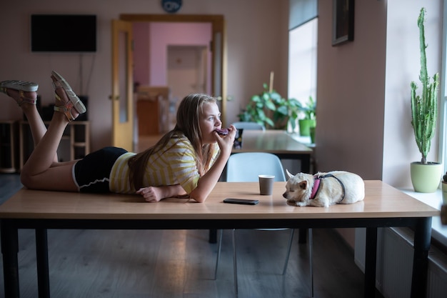 A relaxed US office worker, comfortably working from home, with a pet nearby. The scene should convey ease, informality and autonomy.