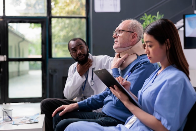 A diverse group of healthcare professionals collaborating on a patient's chronic pain management plan, showcasing an interdisciplinary approach.