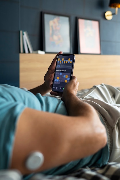 A person reviewing their sleep data on a mobile app connected to their wearable sleep tracker. The app displays graphs and charts showing sleep patterns and recommendations.