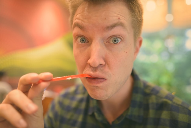 A dentist pointing to swollen and red gums during an oral examination. The image illustrates the visible signs of gum disease that dentists look for during checkups.