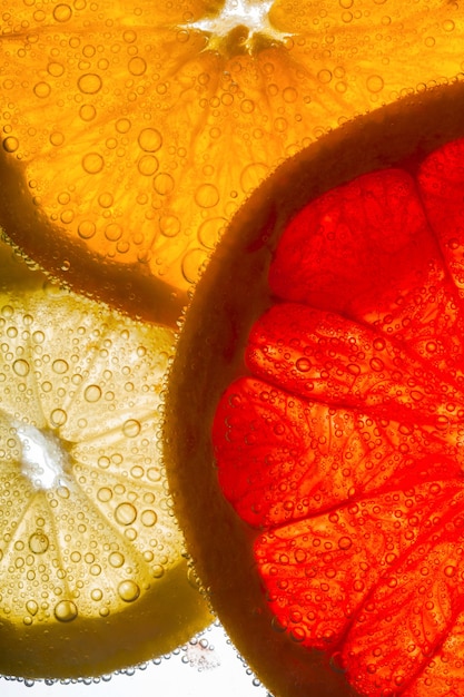 A close-up shot of colorful citrus fruits, such as oranges, lemons, and grapefruits, with droplets of water on their peels, emphasizing their freshness and vitamin C content.