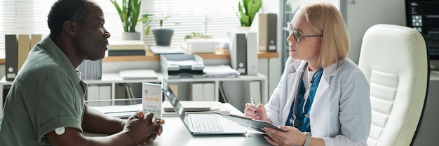 A person consulting with a healthcare professional in their office, discussing gut health concerns and potential probiotic solutions, with a focus on personalized healthcare advice.