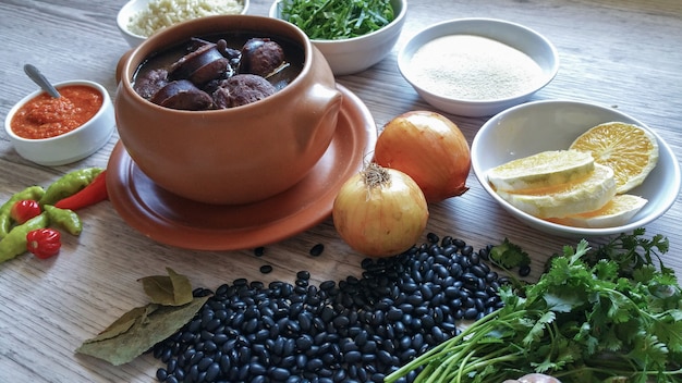 A close-up shot of a variety of colorful beans in separate glass bowls, including black beans, kidney beans, and pinto beans, with a focus on their texture and vibrant colors.
