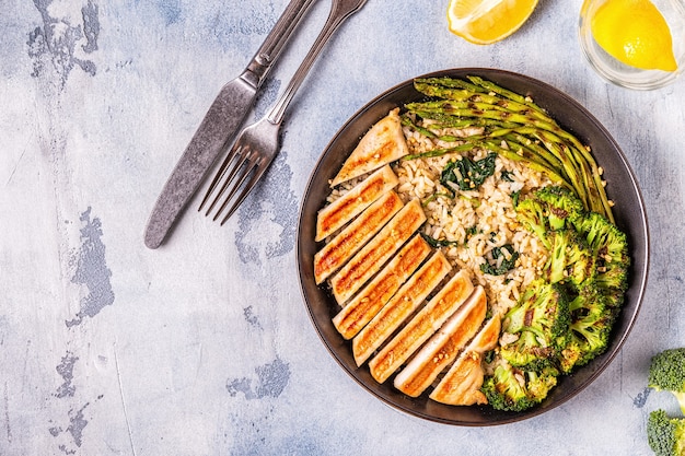 A diverse plate of healthy food, showcasing a balanced meal with lean protein (chicken breast), complex carbohydrates (quinoa), and healthy fats (avocado slices). The image highlights the importance of nutrient-dense foods.