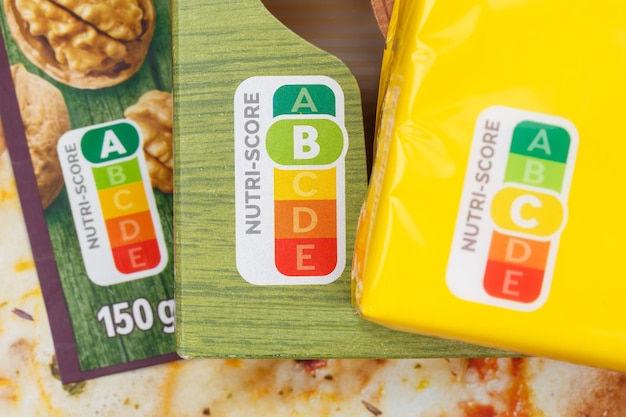 A close-up of a food label on a processed snack, clearly showing the high sugar, salt, and fat content, along with a list of artificial additives and preservatives.