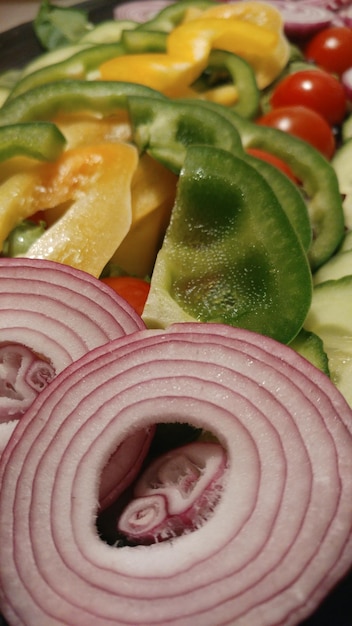 A close-up shot of various fruits and vegetables, some whole and some sliced, highlighting their textures and colors, with a focus on illustrating how processing methods like cooking or juicing can affect their glycemic index.