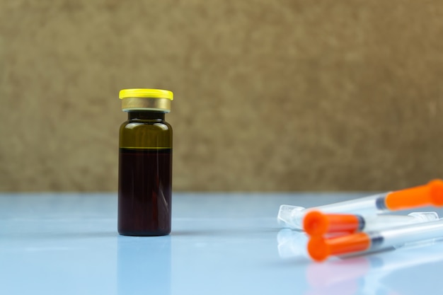 A blood test vial with a vitamin D supplement bottle in the background, highlighting the importance of regular testing to monitor and maintain adequate vitamin D levels.