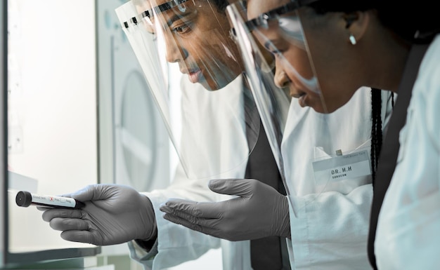 A close-up image of medical professionals analyzing cancer screening results in a laboratory setting, using advanced technology to identify potential warning signs.